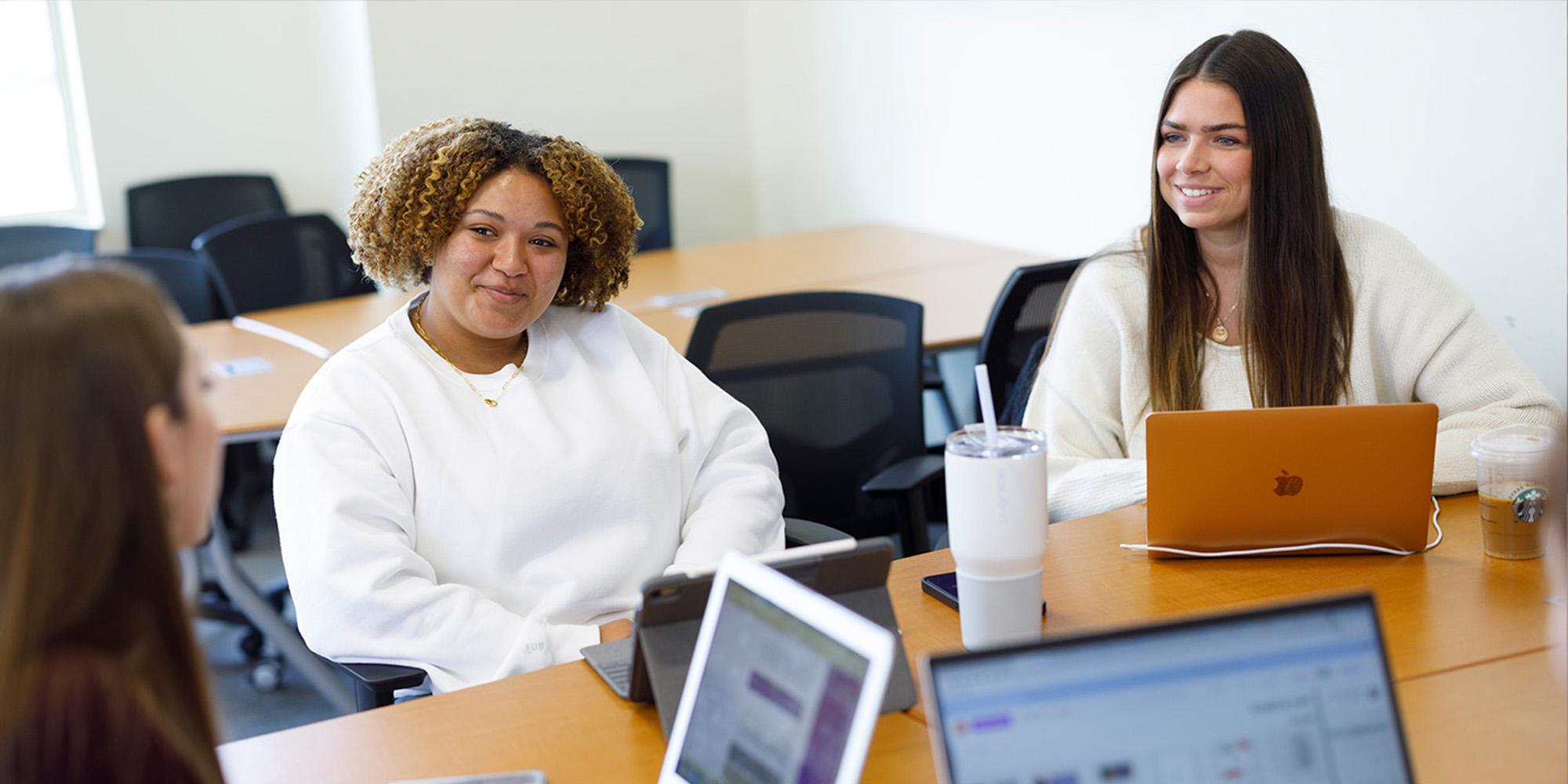 Three Female Students In Communication Discussion